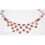 A contemporary 18ct gold and garnet necklace, the oval cut garnets in fine chain links and