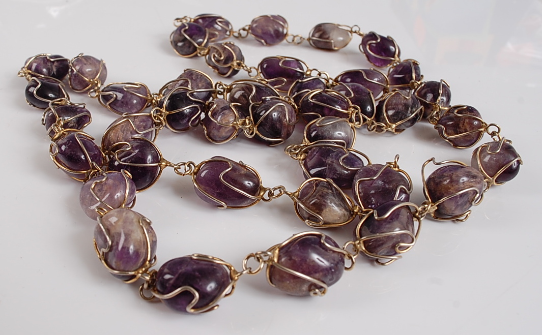 An opera length amethyst necklace, featuring 40 oval amethyst polished stone beads within wire twist - Image 2 of 2