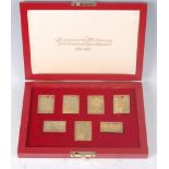 A cased set of The Coronation Issue silver gilt replica stamps, to commemorate the 25th