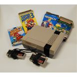 A Nintendo Entertainment System with two controllers and four games; Super Mario 2, Super Mario 3,