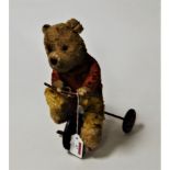 A 1950s Chilton Products child's push-along bear on tricycle, height 27cm