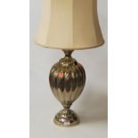 A modern chromed table lamp of melon form to circular footrim, with silk shade, height 66cm (