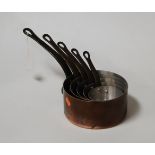 A graduated set of five copper saucepans, each with iron handle, largest dia. 18cm