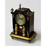 An early 20th century green and gilt painted mantel clock of pagoda shape with turned finials