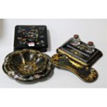 A Victorian black lacquered and mother-of-pearl inlaid desk stand, having twin glass inkwells and