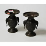 A pair of modern Chinese bronze vases of baluster form, relief decorated with a dancing figure