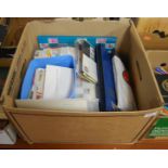 A box of miscellaneous loose stamps, stamp albums, and first day covers