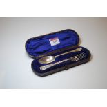 A George V silver christening fork and spoon in fitted blue velvet lined leather case