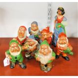 A set of painted and glazed terracotta figures of Snow White and the Seven Dwarfs, height of Snow