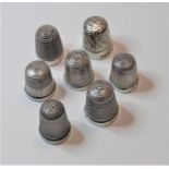 A collection of seven various silver and sterling silver thimbles