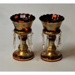 A pair of early 20th century Bohemian style ruby glass and gilt overlaid table lustres having