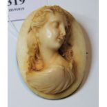 A late 19th century ivory brooch, carved as a female head and shoulders bust in profile, in white