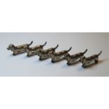 A set of six silver plated knife rests, each in the form of a dachshund, length 6.5cm