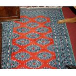 A Persian woollen red ground Bokhara rug, having trailing tramline borders, 180 x 126cm