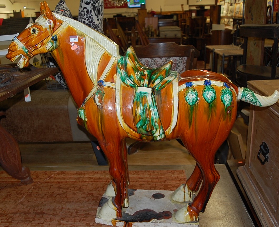 A large contemporary Tang style glazed pottery model of a standing horse, having removable tail