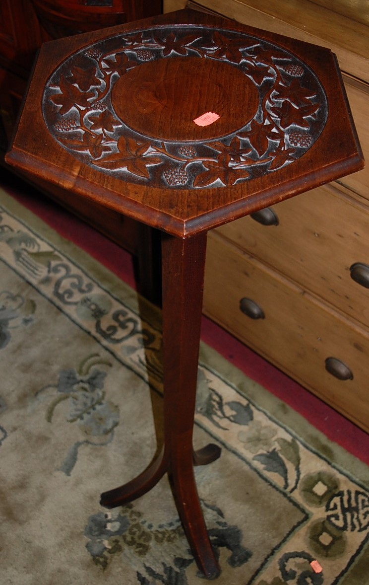 An early 20th century hexagonal topped relief carved walnut pedestal occasional table, h.95.5cm