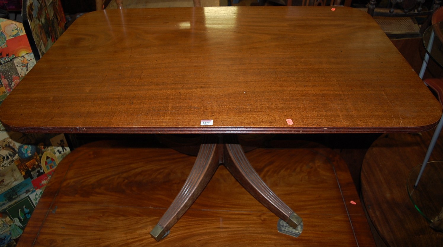 A 19th century mahogany reeded round cornered tilt-top pedestal breakfast table, on reeded