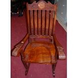 A contemporary Indian relief carved teak and floral brass inlaid panelled seat rocking open elbow