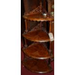 A mid-Victorian figured walnut and floral satinwood strung four-tier bowfront whatnot, of