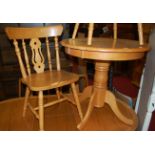 A contemporary rubber wood circular pedestal kitchen table, with four chairs (5)