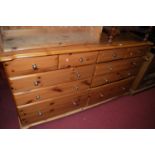 A modern pine sideboard, fitted with four short drawers over six long drawers, w.159cm