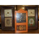 Two early 20th century American droptrunk wall clocks; together with another wall clock (3)