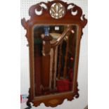 A circa 1900 Chippendale style fret carved bevelled wall mirror, having scallop shell lower inlay