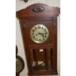An early 20th century oak droptrunk wall clock