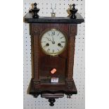 A small early 20th century partially ebonised oak droptrunk wall clock