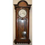 An early 20th century walnut Vienna droptrunk wall clock, having single weight and pendulum