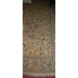 A Persian woollen Tabriz rug, the stylised floral central ground within trailing tramline borders,