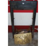 An Art Nouveau painted cast iron and embossed floral brass decorated fireplace