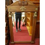 An Empire style mahogany and cast brass mounted overmantel mirror, with floral carved top rail,