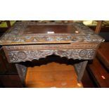An early 20th century Chinese relief carved hardwood small low occasional table, having pierced