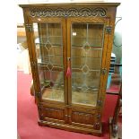 A contemporary Old Charm lead glazed double door display cabinet, having twin linenfold panelled