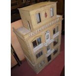 A Georgian style painted pine three-storey dolls house, each level having a hinged opening, with