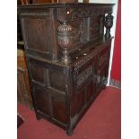 A 17th century style joined and relief carved oak court cupboard, w.138cm