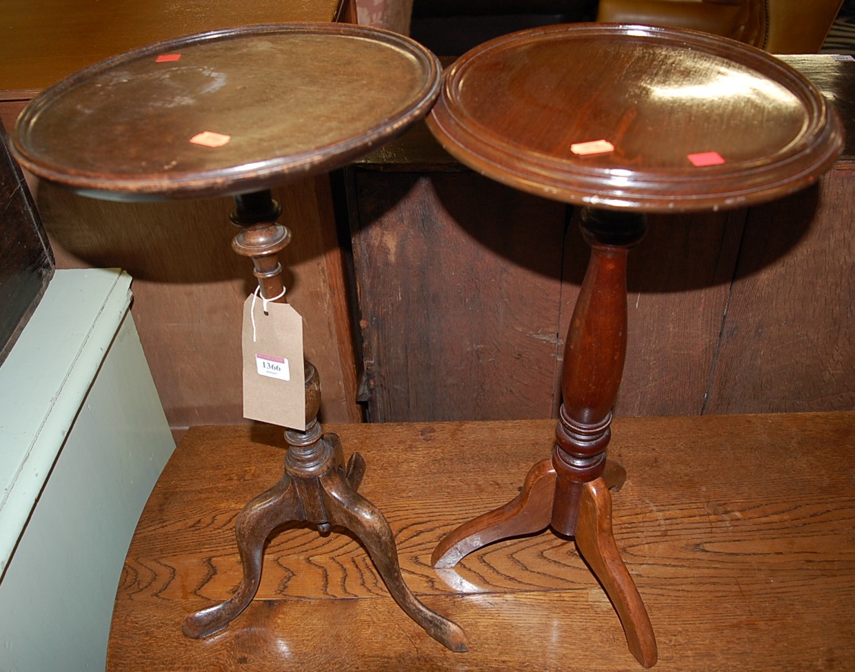 A reproduction mahogany circular pedestal low wine table, together with one other similar example (