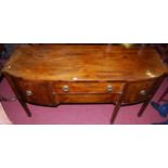 A 19th century mahogany bowfront sideboard, having twin central drawers flanked by cupboard door and