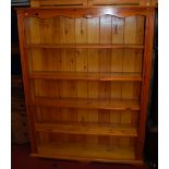 A modern stained pine freestanding open bookshelf, of good size, w.139cm