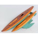 Two Bowman Models of Dereham wooden pond yacht hulls comprising of stained wooden desk with lower