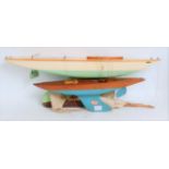 Two various sized Bowman Models of Dereham wooden hulled pond yachts both of various colours and