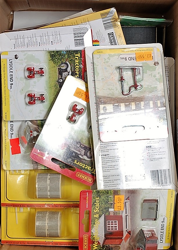 A large shoebox containing unopened Hornby "Lyddlend 9 Mil" accessories including station platforms,