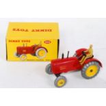 A Dinky Toys No. 300 Massey Harris tractor comprising of red body with brown driver and yellow hubs,