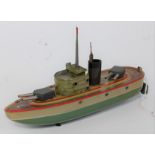 A Kellermann tinplate and clockwork gun ship comprising of two-tone green and cream hull with nicely