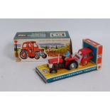 A Britains No. 9529 Massey Ferguson 135 tractor, comprising of grey, red and white body with