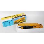 A Conrad No. 2082 1/50 scale model of a Liebherr LTM 1160 6-axle mobile crane, comprising yellow and