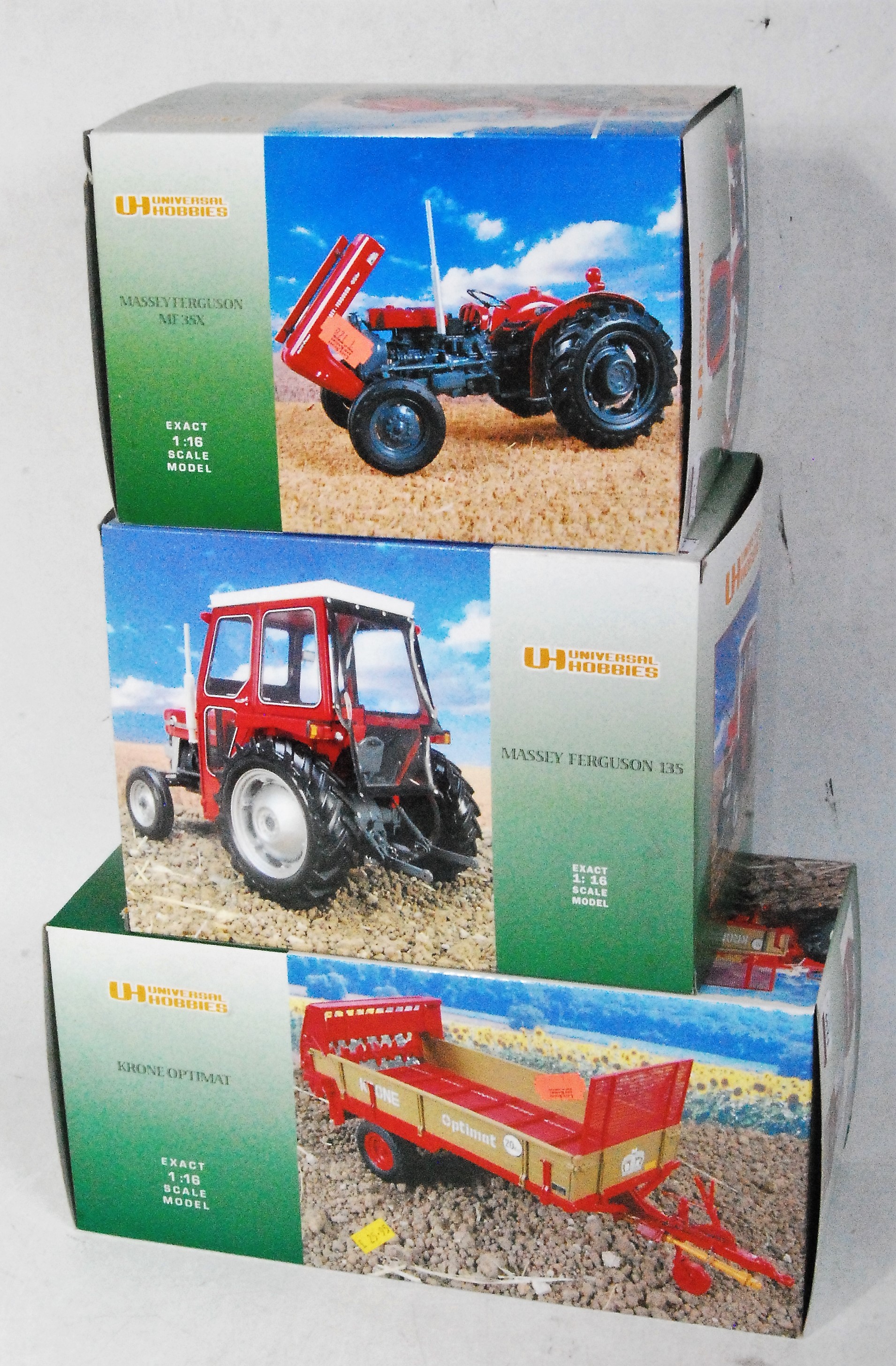 Three various boxed as issued Universal Hobbies 1/16 scale model tractors and tractor implements