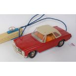 A Gama Models tin plate and plastic battery operated model of a Mercedes Benz 230SL saloon