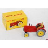 A Dinky Toys No. 300 Massey Harris tractor comprising of red body with yellow hubs and brown driver,
